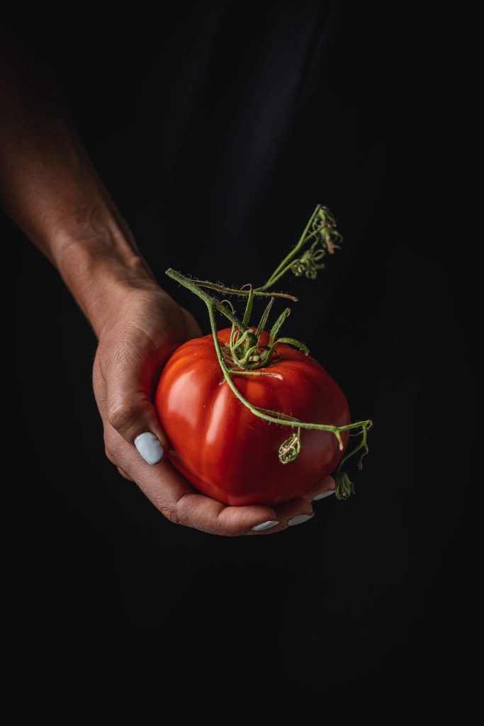Red tomatoes in hands